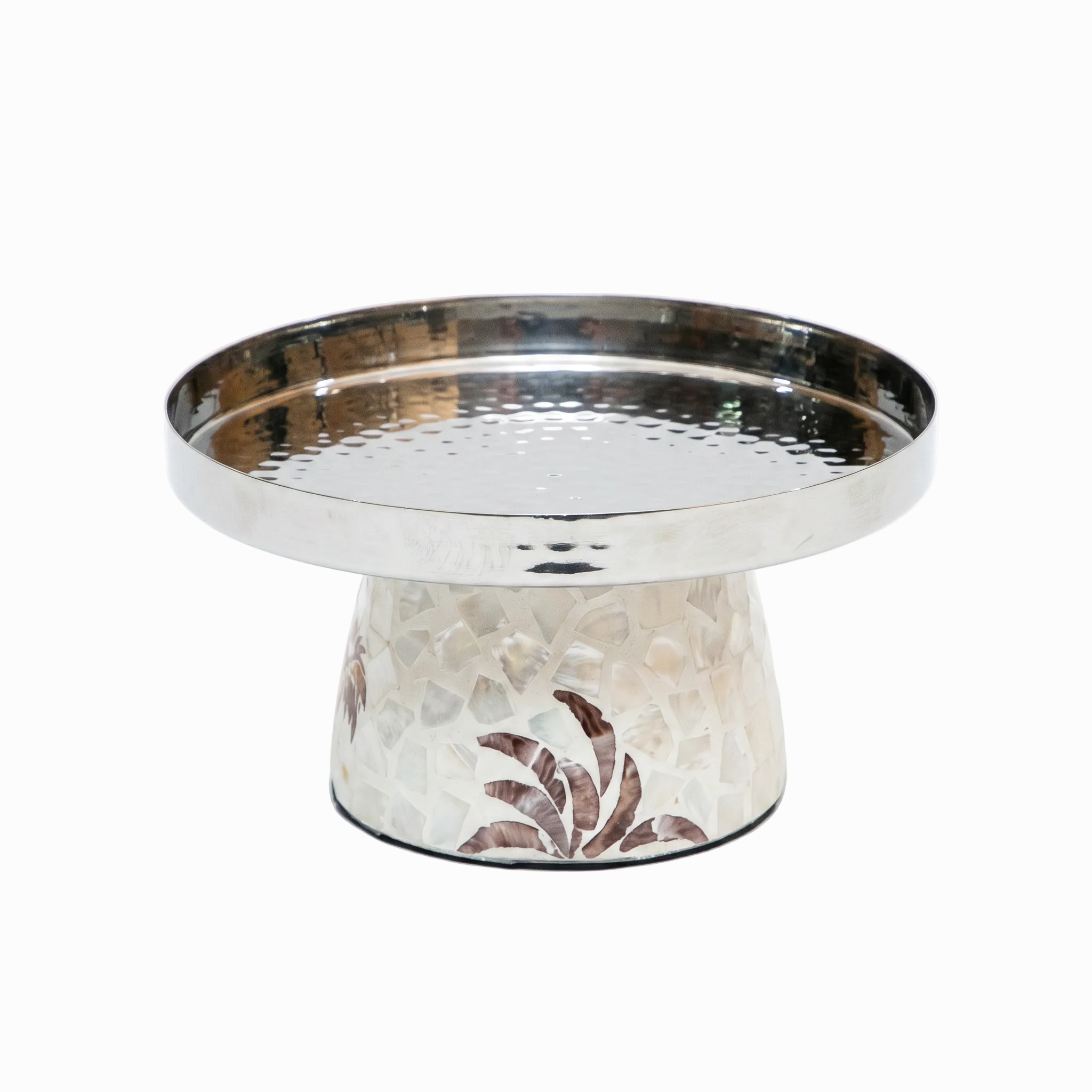 A small decorative pedestal tray or cake stand with a hammered silver-toned metal rim and base, and a textured off-white center decorated with brown floral motifs, shown on a plain white background.
